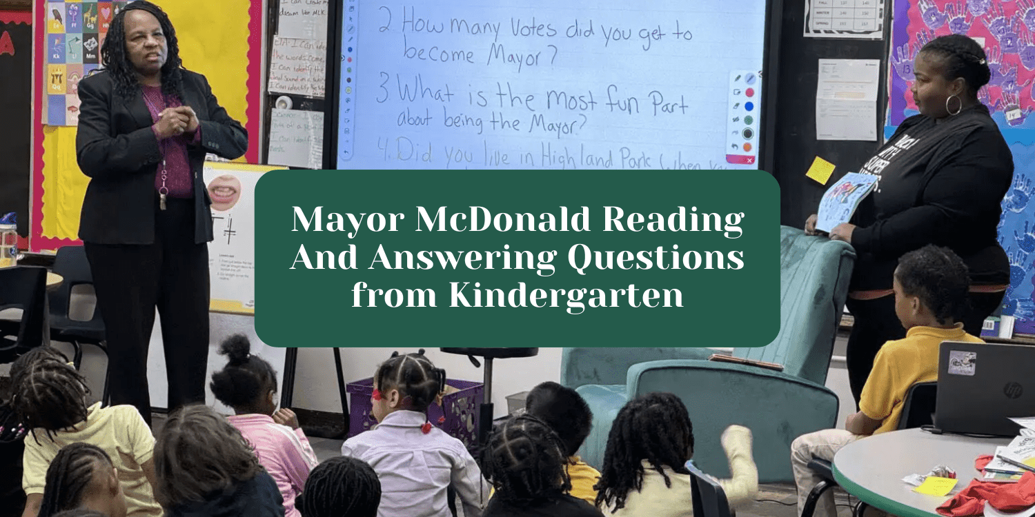 Adults and children in a classroom with questions on a screen.