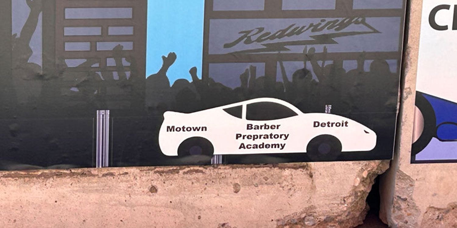 Mural with white car, text, and silhouetted figures.
