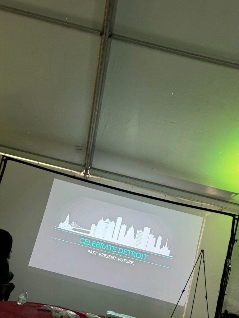 Projected graphic with Detroit skyline and "Celebrate Detroit" text.