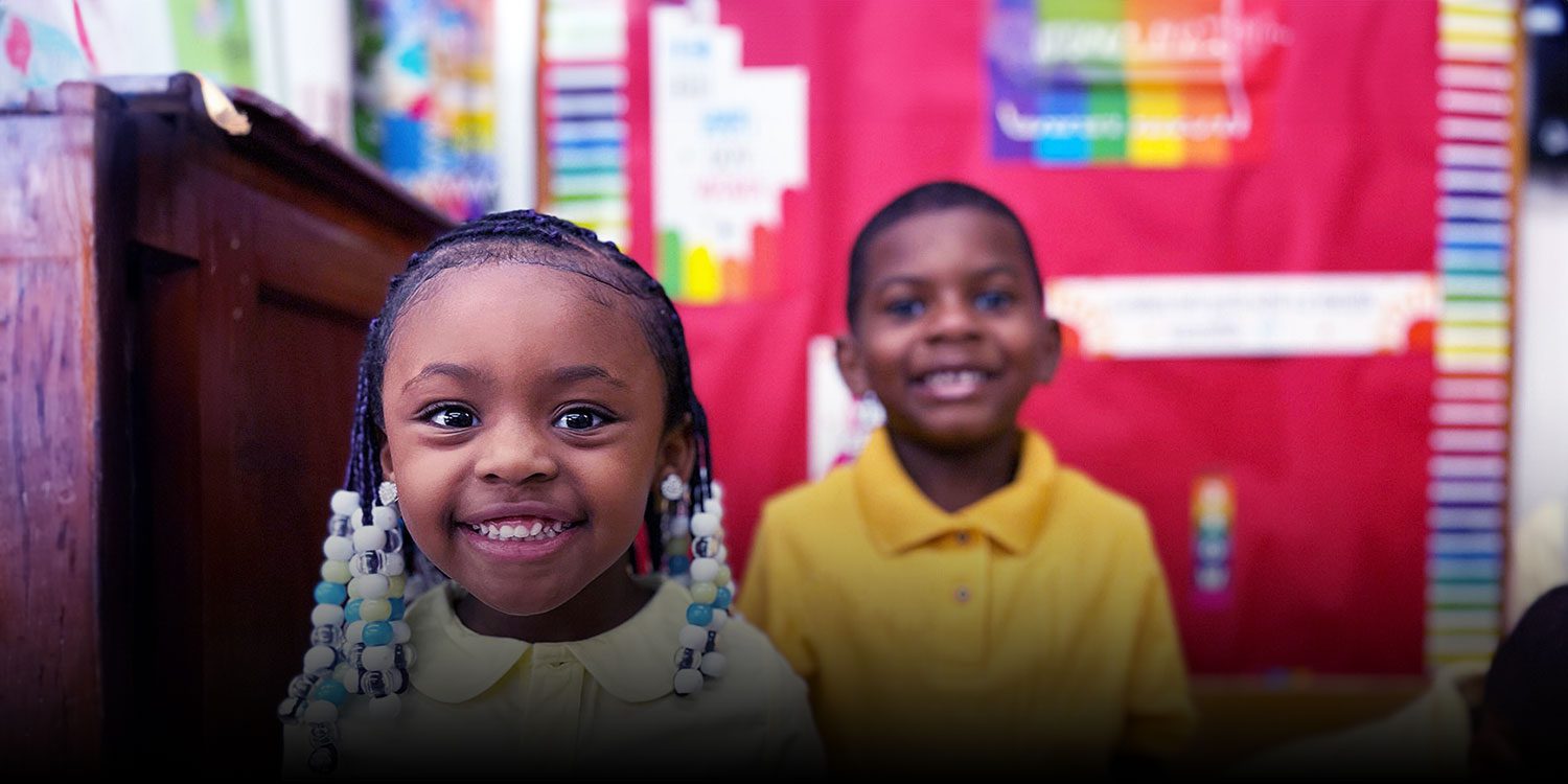 Students smiling in a classroom